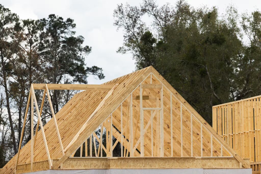 Steep roof under construction, with layers of shingles and equipment visible during a residential roof installation project.