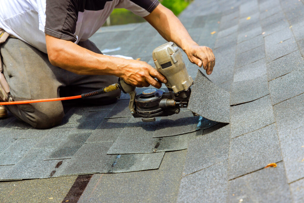 Roofing contractor in Middleton, WI installing new shingles during roof replacement