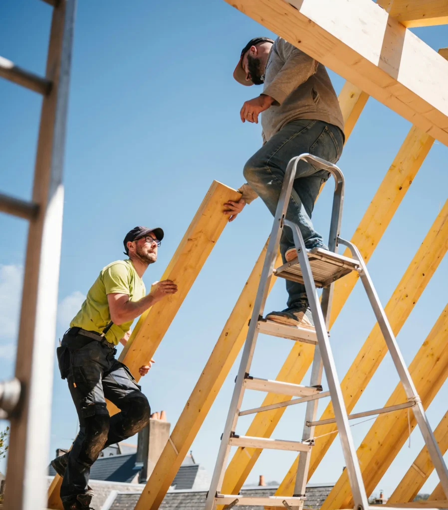 Roofing professionals performing structural roof installation work on a Maple Bluff WI property